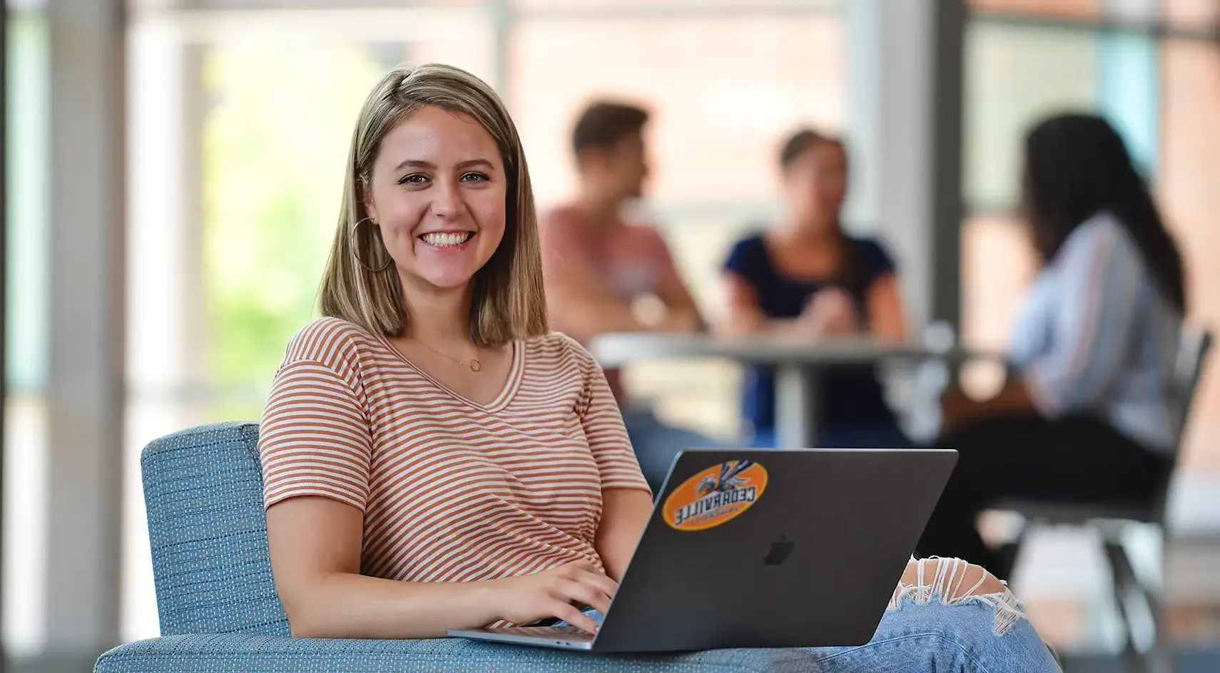 woman working with her laptop on her lap